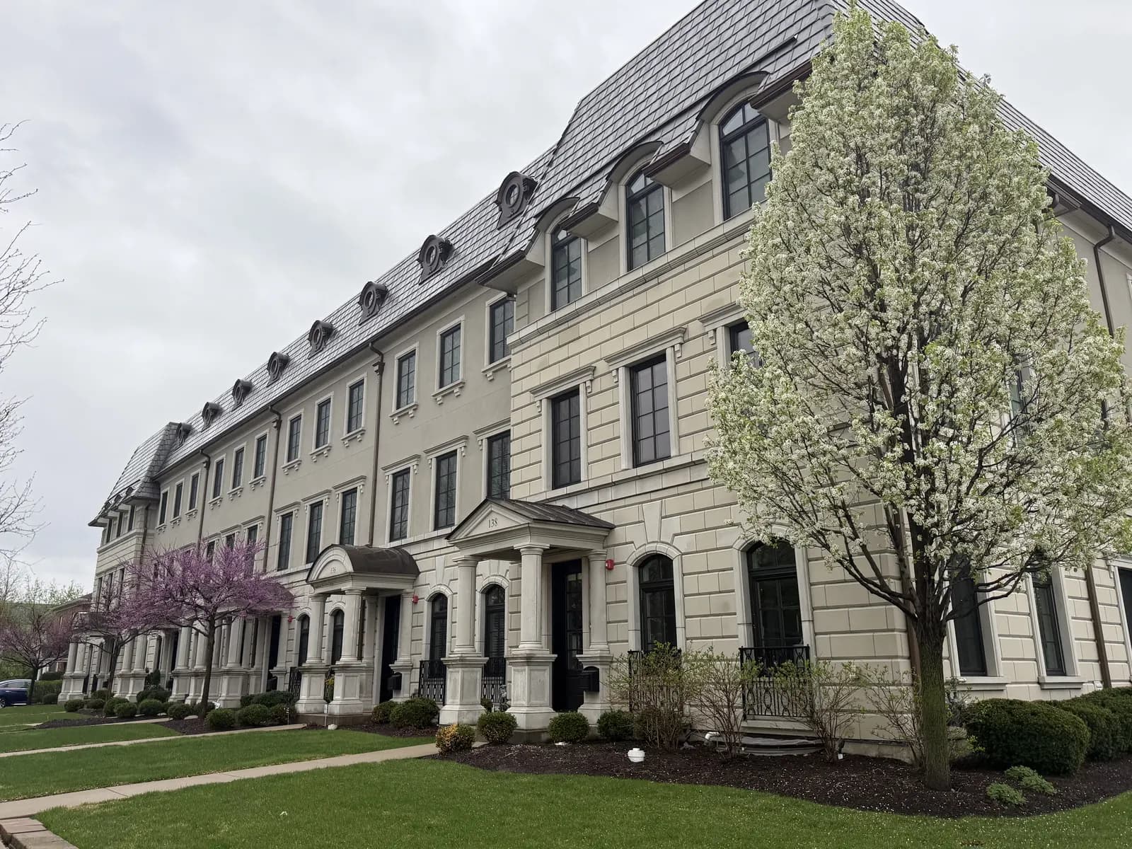 Row of stone townhomes with black-frame windows