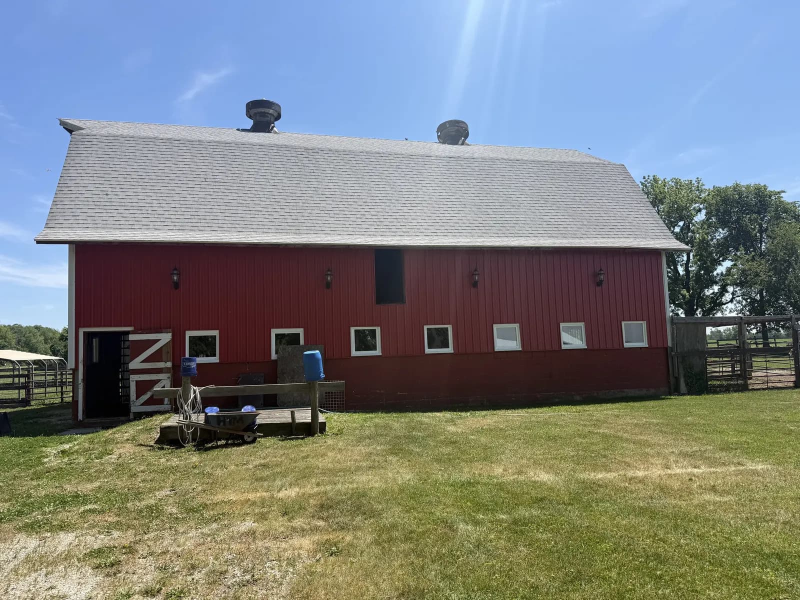 Red barn with a row of new white windows